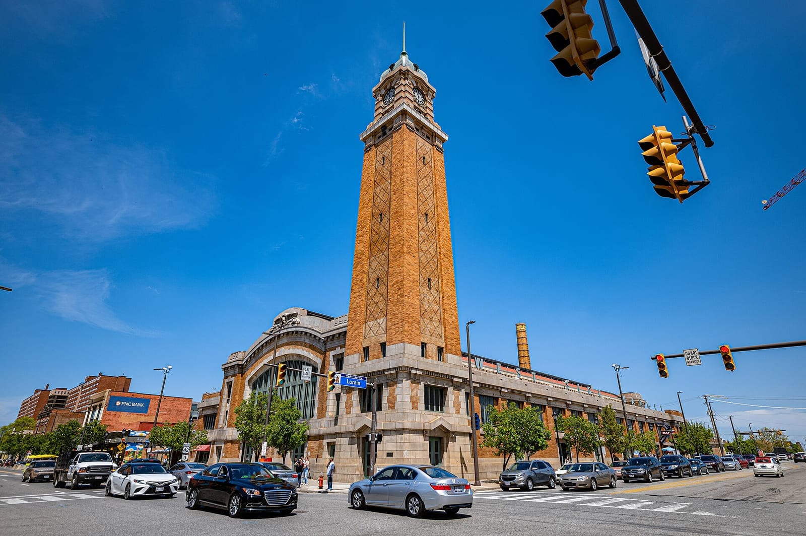 The West Side Market's peaked tower and brick facade anchor a Cleveland street corner.