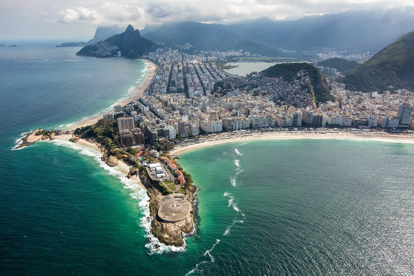 Copacabana's fort-tipped headland and curving high-rise beachfront curl into the sea, framed by jungle peaks
