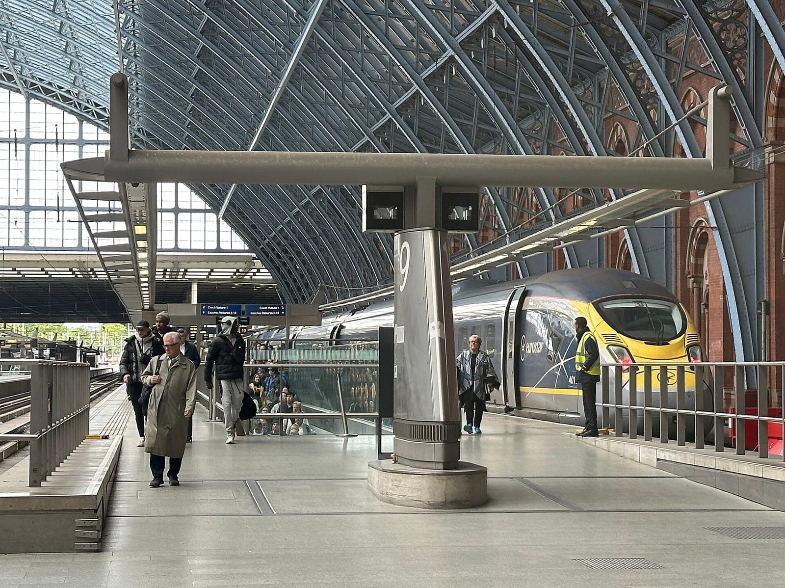 A Eurostar train waiting at a platform under the iron roof of St Pancras station