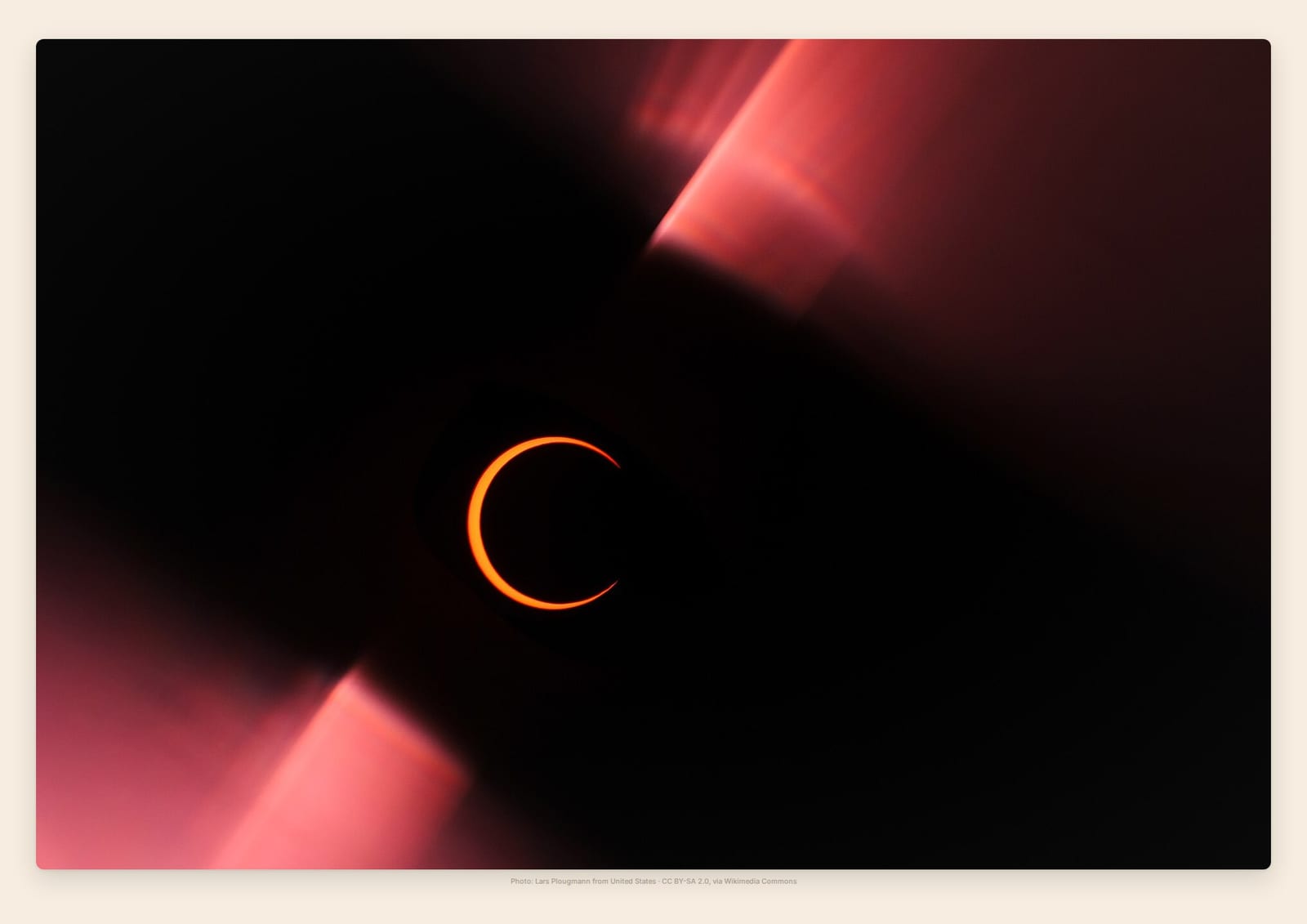 A blazing ring of orange sunlight glowing around the moon at an annular eclipse's peak