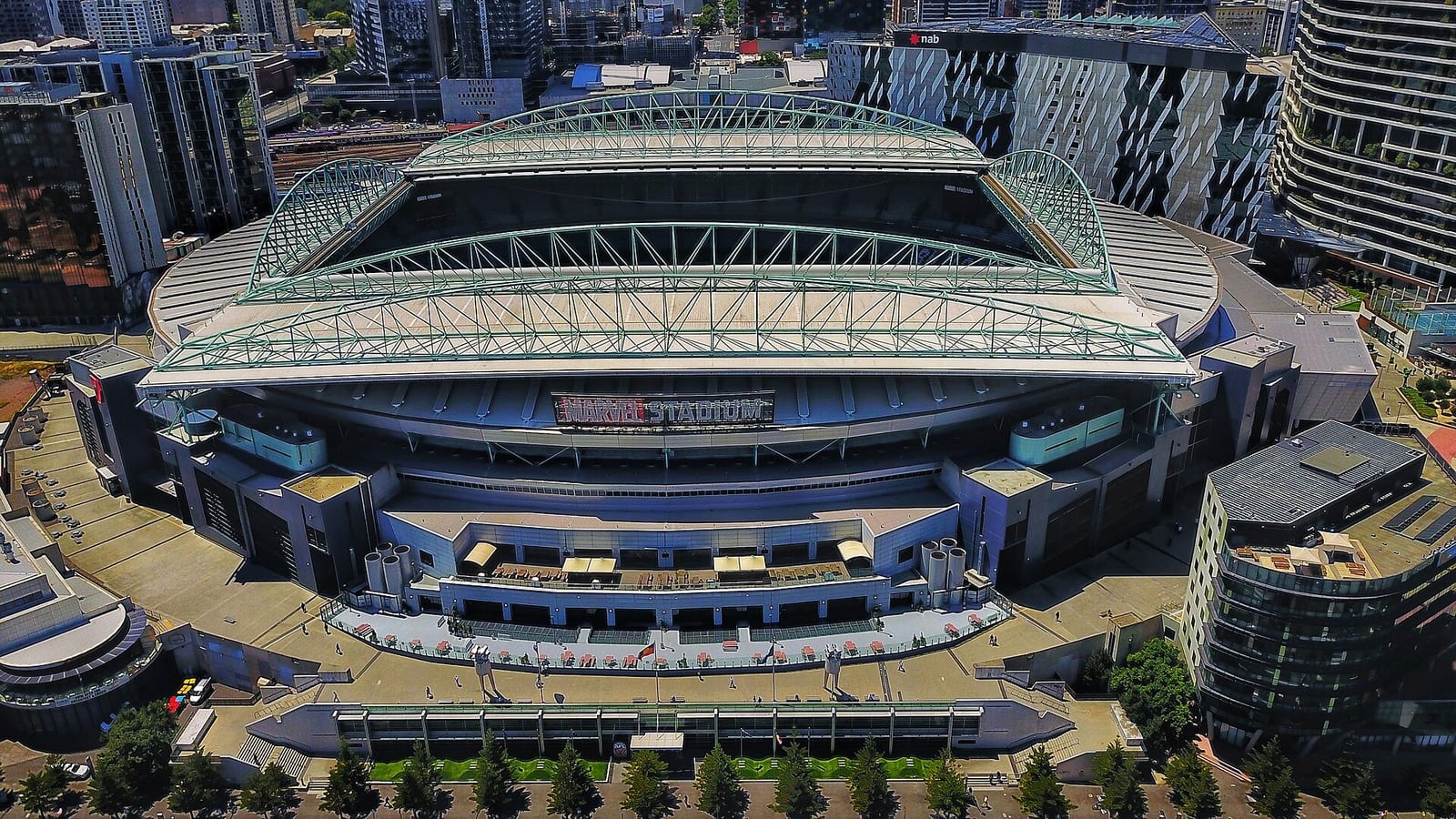 Marvel Stadium in Melbourne's Docklands seen from above, its roof trusses spanning the ground