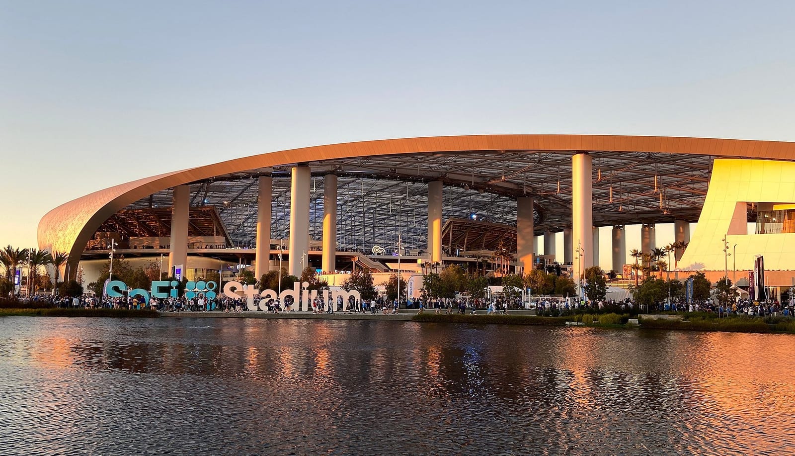 SoFi Stadium's glass and steel facade in daylight, host of Super Bowl LXI in February 2027